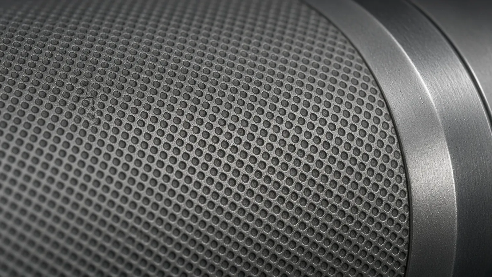Close view of a ceramic roller surface covered in a regular grid of engraved cells